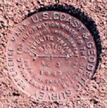 Brass monuments permanently affixed in concrete or surrounding bedrock indicate accurate geodetic reference positions within the NGS horizontal and/or vertical datums. Photo: NOAA