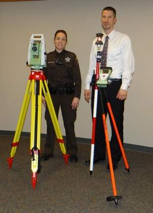 Dodge County Crash Investigation Team members Deputy Jaime Buelter, left, and Detective Ted Sullivan train on the newly acquired robotic total station that will help officers collect evidence at crime/crash scenes more quickly and with less manpower. Image Source: fdlreporter