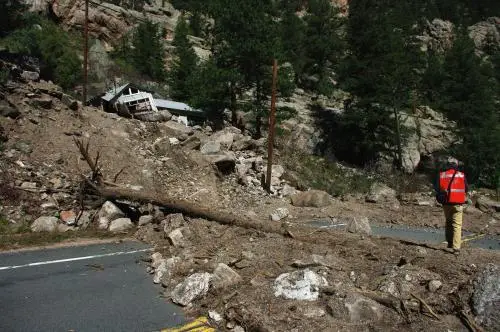 House damaged by Sept. 2013 debris flow in Big Thompson Canyon, Colorado Front Range; deposit covers part of US Hwy 34. Credit: Jonathan Godt, 20 Sept. 2013; published on the cover of the Oct. 2014 issue of GSA Today.
