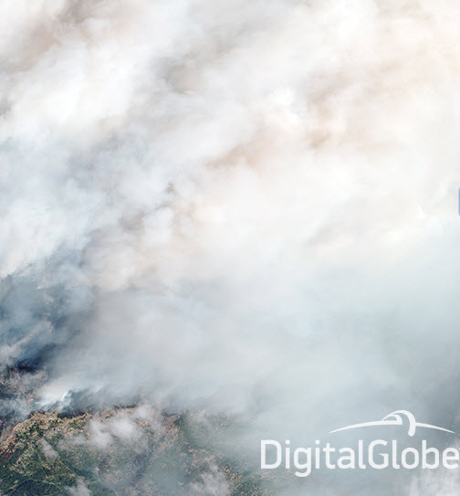 The SWIR image is a “false color” composite made from three of the eight SWIR bands (bands 6, 3, and 1) that coincidentally give an orange color to the fire.  Credit: DigitalGlobe