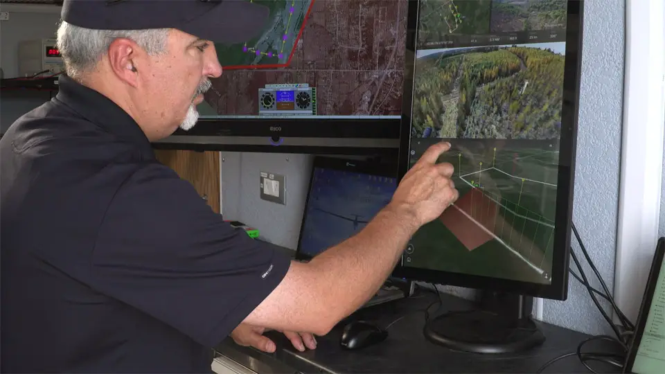 Program director Paige Cutland uses IRIS UAS sofware installed at a portable ground control station to visualize the flight path of a large UAV during a BVLOS flight trial. Credit: Kongsberg Geospatial